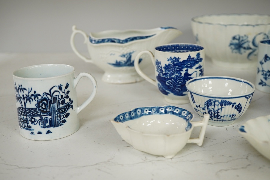 A collection of first period Worcester blue and white porcelain to include a Fence pattern sparrow-beak jug, a fluted Gilly-flower pattern bowl, a peony rock bird scallop shell pickle dish, a butter boat, a fisherman and